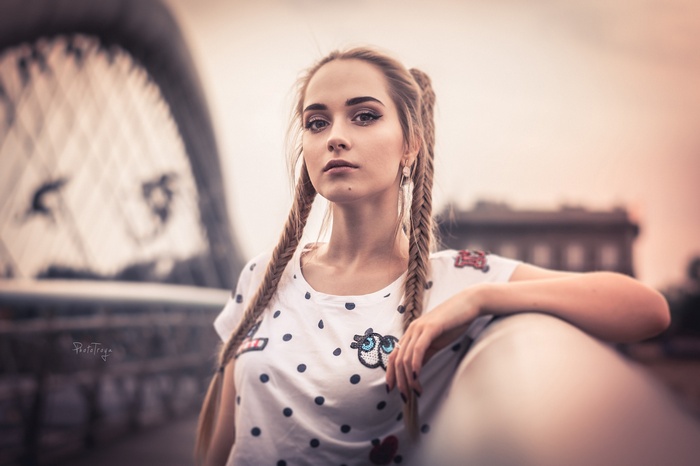 Woman with pigtails leaning on a railing