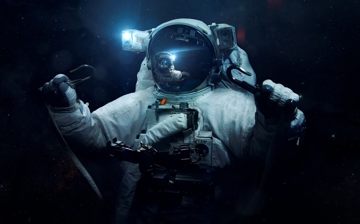 Astronaut in space holding tools