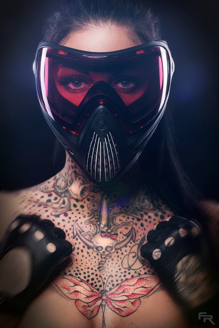 Woman wearing a mask and gloves with tattoos