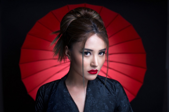Woman with red lipstick and umbrella