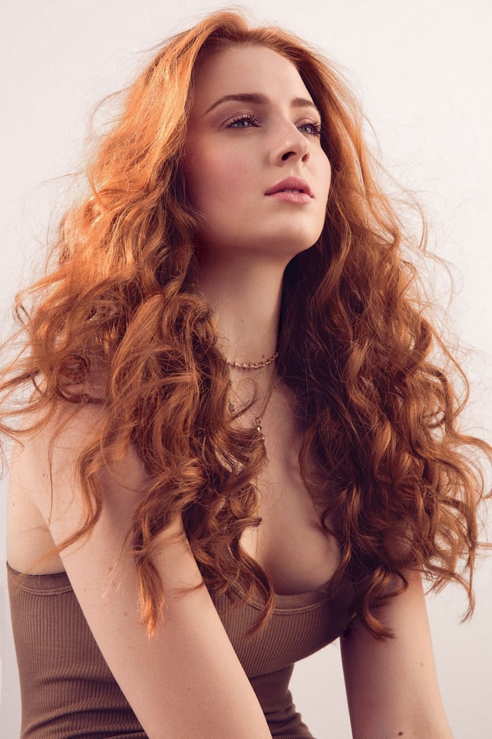 Sophie Turner with red curly hair and necklace