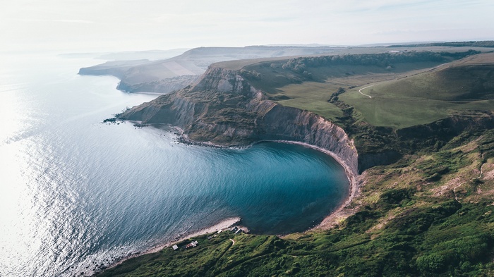 Aerial view of a coastal cliff and bay