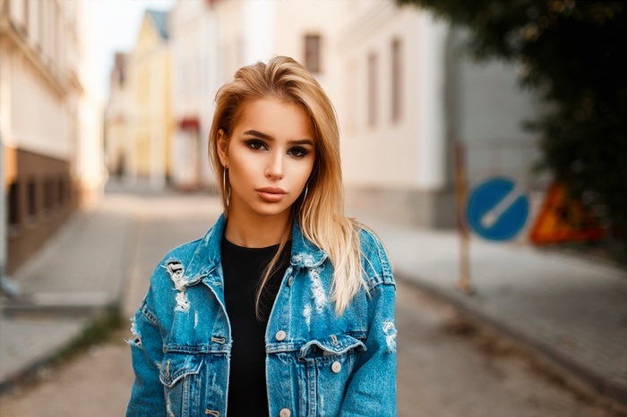 Woman with blonde hair in a denim jacket