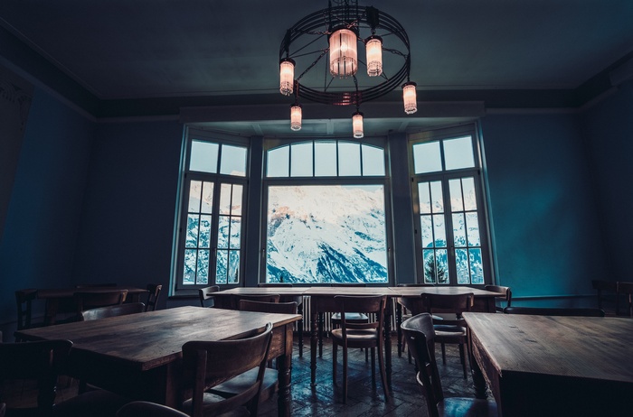 Dining room with large window overlooking snowy mountains