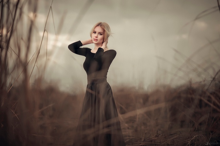 Woman in black dress in field