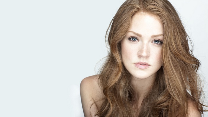 Maggie Geha with long brown hair and blue eyes