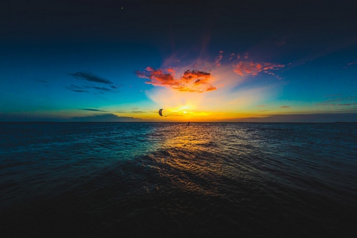 Kitesurfer on the sea at sunset
