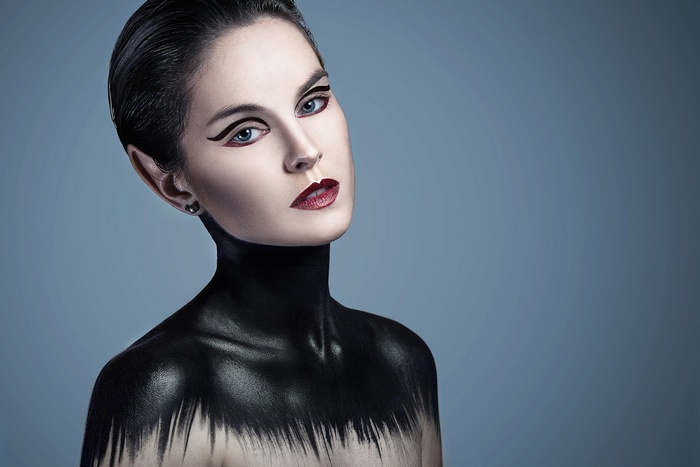 Woman with dramatic black body paint and makeup