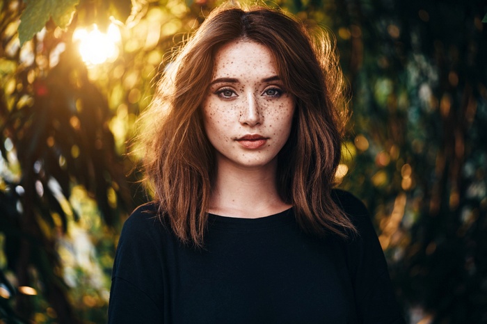 Woman with freckles in sunlight