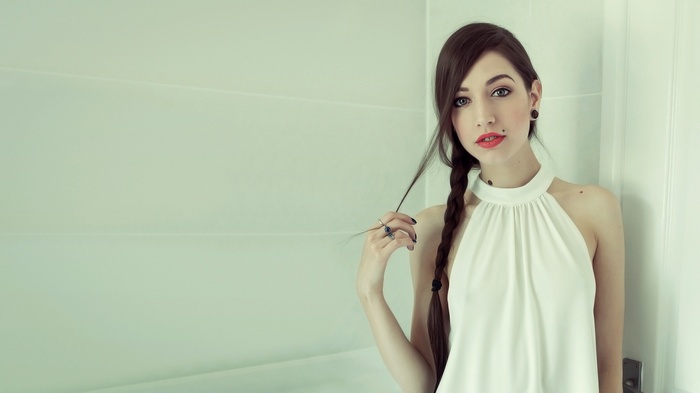 Woman with braided hair and red lipstick looking at viewer