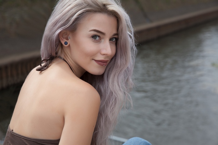 Woman with dyed hair and piercings outdoors