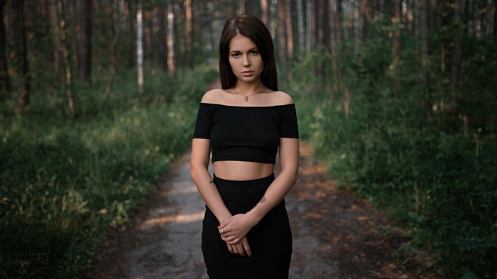 Woman in black clothing in a forest