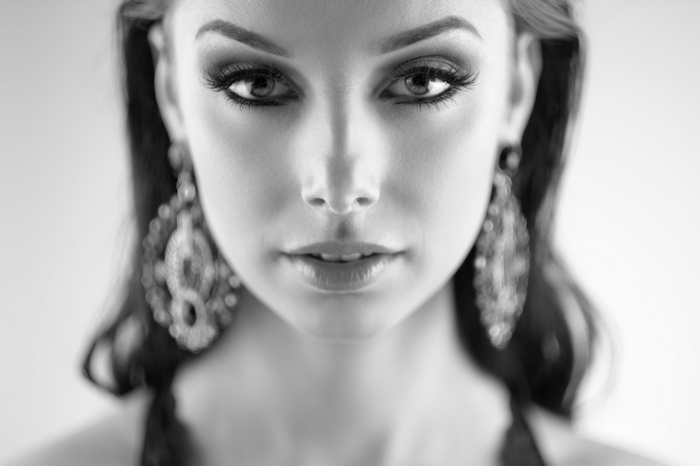 Monochrome portrait of a woman with large earrings