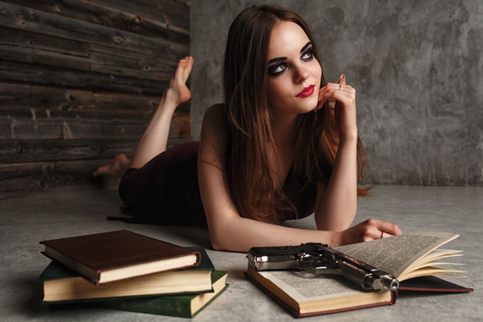 Woman with gun and books