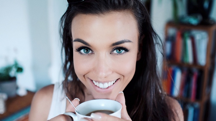 Gina Carla smiling with coffee cup