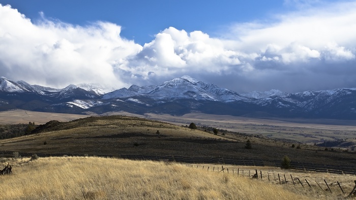 Snow-capped mountains under a cloudy sky