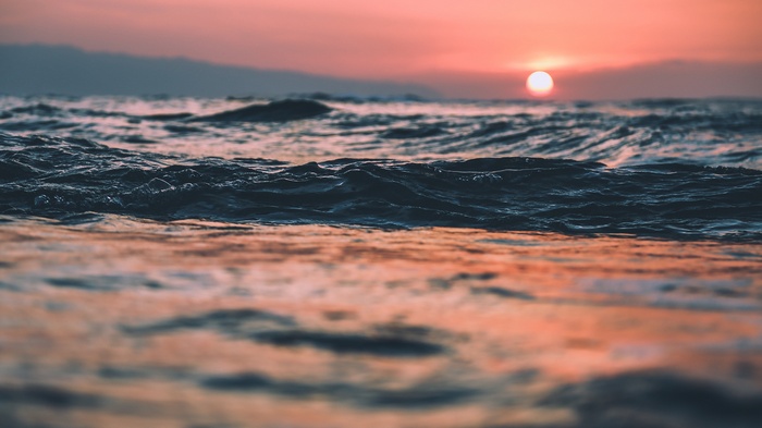 Sunset over the ocean waves