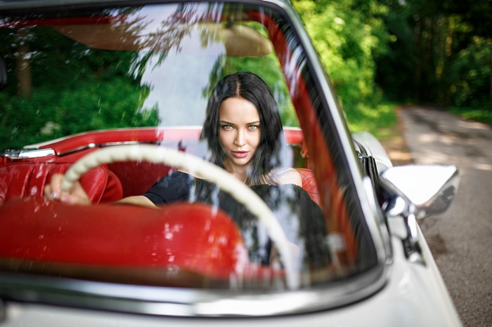 Angelina Petrova driving a vintage car