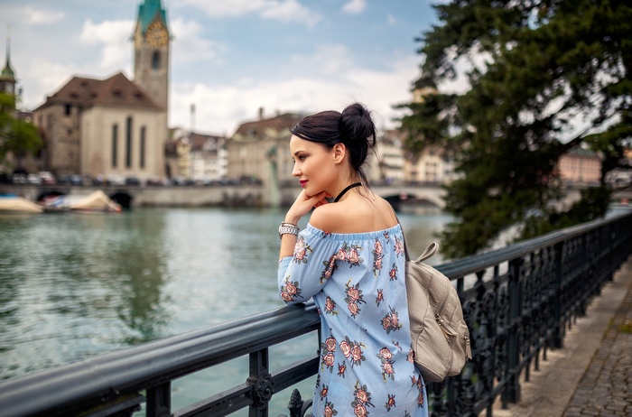 Woman in blue floral dress by the river in Zurich
