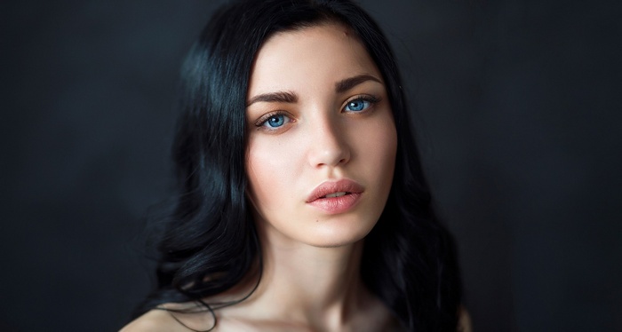 Woman with long dark hair and blue eyes