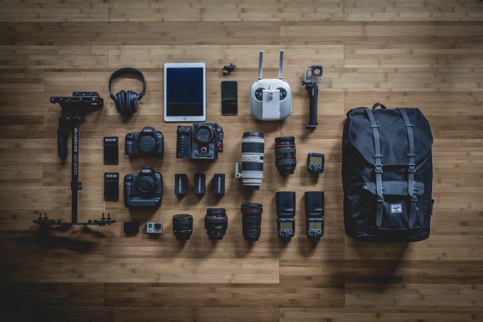 Photography equipment laid out on a wooden surface