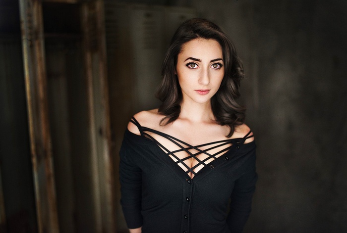 Woman in black off-the-shoulder top looking at viewer