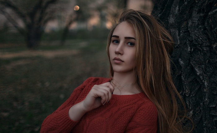 Young woman with blonde hair in a red sweater