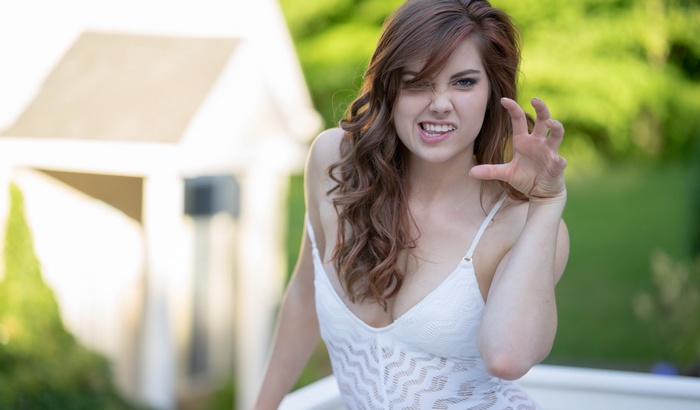 Woman with long brown hair making a fierce face