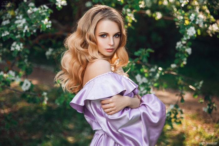 Woman with blonde hair in a purple dress