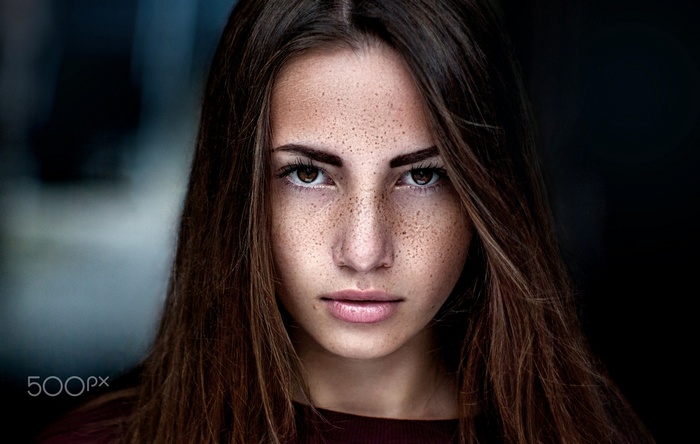 Woman with freckles looking at viewer
