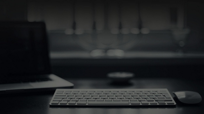 Laptop, keyboard, and mouse on a desk
