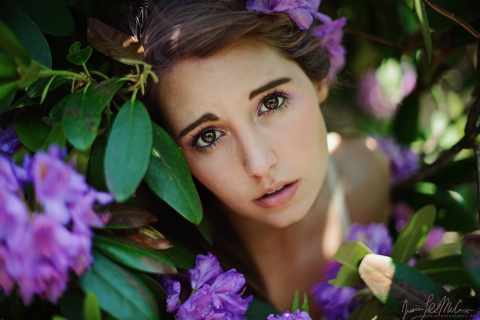 Jessica LaRue McCann among purple flowers and green leaves