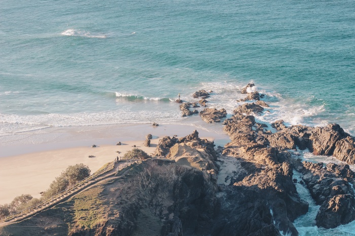 Rocky coastline with a sandy beach and turquoise ocean