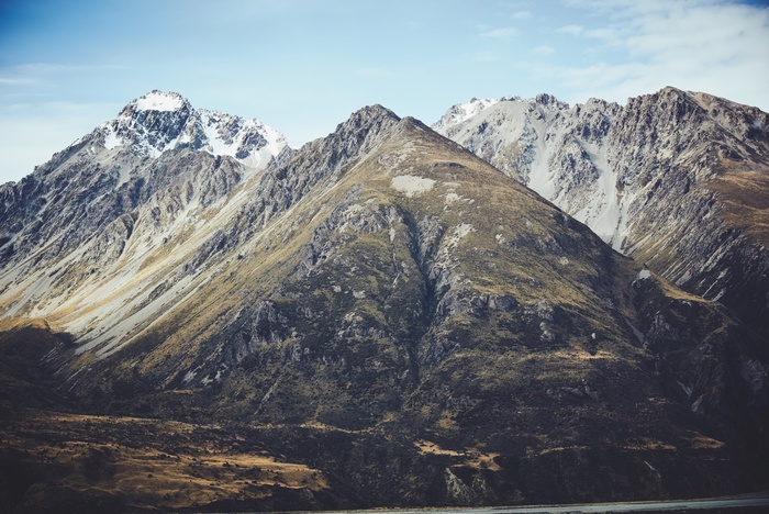 Snow-capped mountains under a blue sky