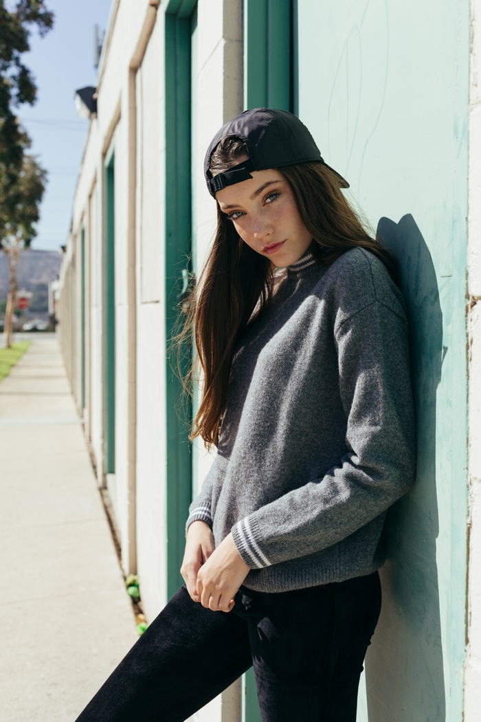 Chloe Bechtol wearing a baseball cap and sweater