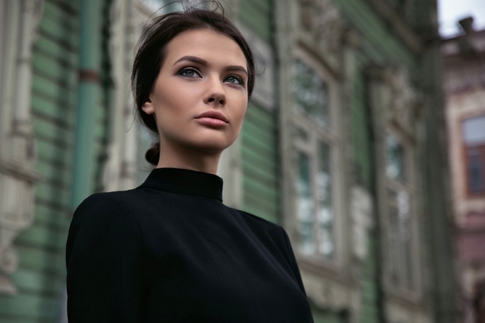 Woman in black dress standing outdoors