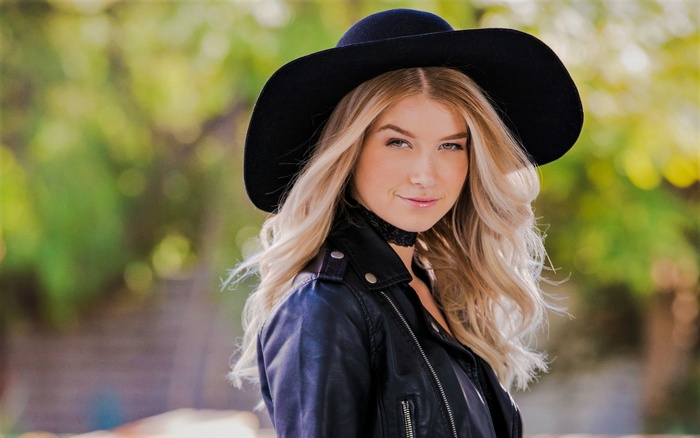 Woman in black hat and leather jacket