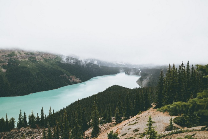 Turquoise lake and misty mountains in Canada