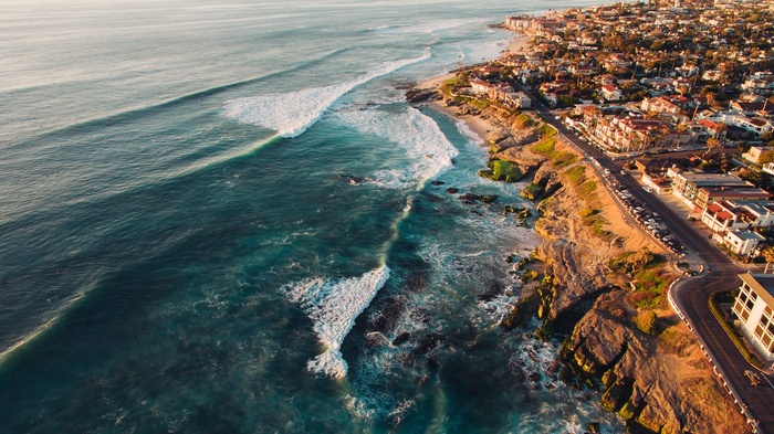 Coastal town with ocean waves and rocky shore
