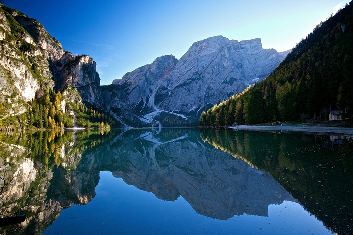 Lake and mountains reflection in Italy