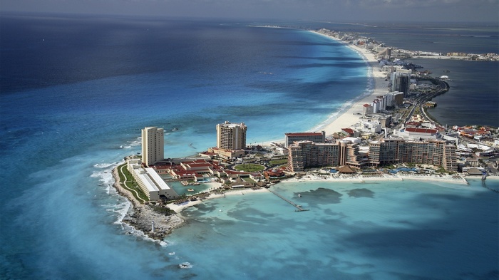 Aerial view of Cancun coastline with hotels and ocean