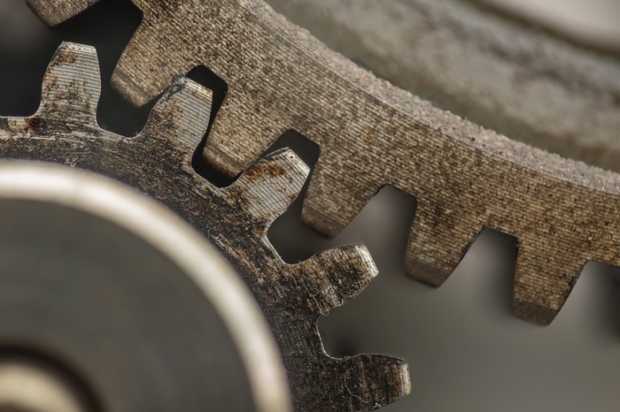 Close-up of two rusty metal gears