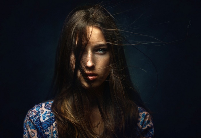 Woman with hair blowing across her face