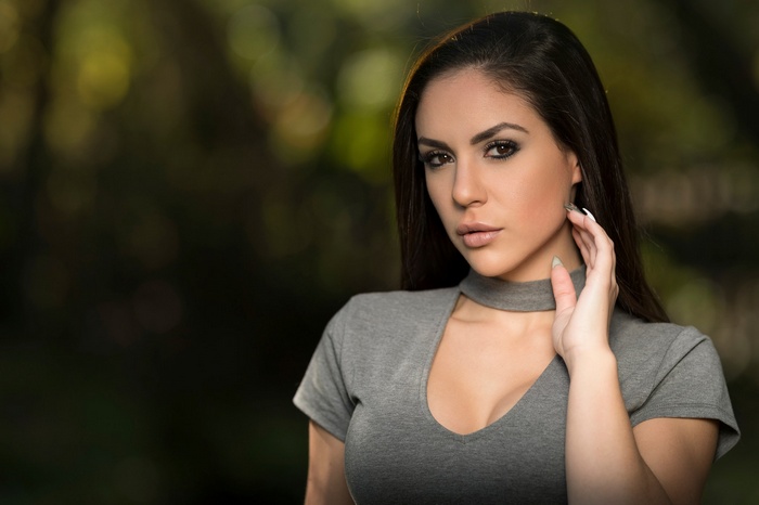 Woman with dark hair in a grey shirt