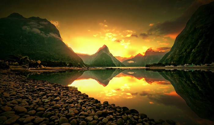 Sunset over Milford Sound, New Zealand with mountains and reflection