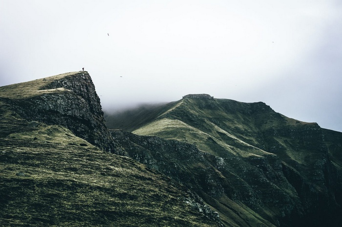 Lone person on a cliff edge in Faroe Islands