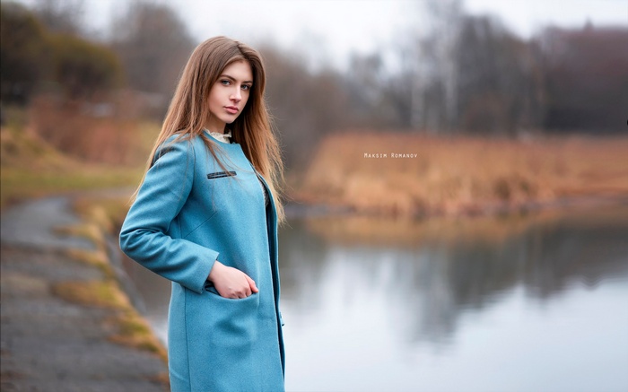 Woman in blue coat by lake, Maksim Romanov