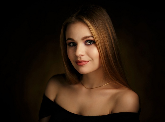 Woman with bare shoulders and necklace