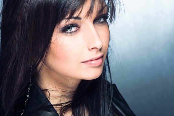 Woman with long dark hair and leather jacket