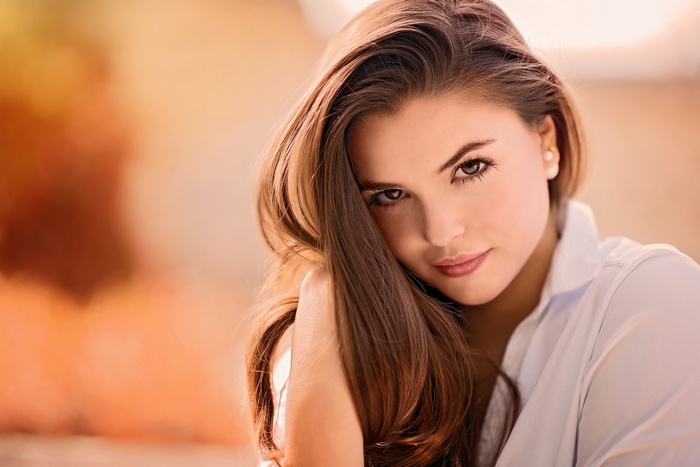 Portrait of a young woman with long brown hair and brown eyes
